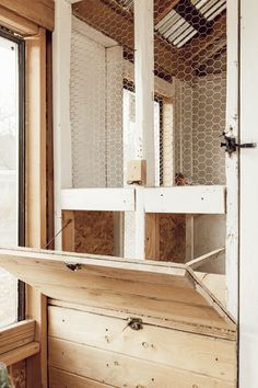 the inside of a house with chicken wire on the ceiling and windows in it,