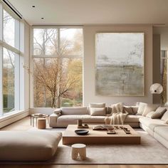 a living room filled with furniture and large windows