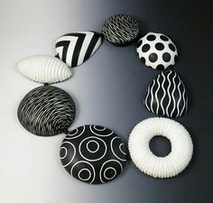 several black and white objects are arranged in a circle on a gray surface with circles