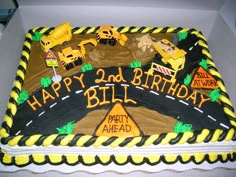 a birthday cake with construction themed frosting in a box