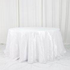 a round table with white cloth on it