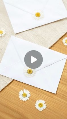 an open envelope with daisies on it