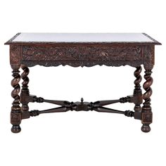 an old wooden table with marble top and carved carvings on the legs, isolated against a white background