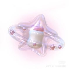 a pink and white baby bottle with stars on it's side is floating in the air