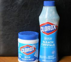 a bottle of clorox and a container of bleach crystals on a table