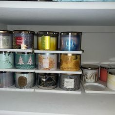 the shelves are filled with many different types of jars and containers, all lined up in rows