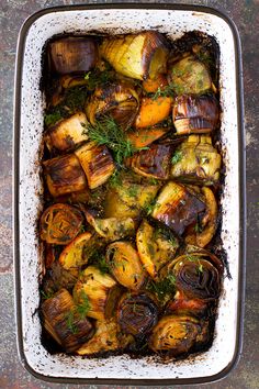 roasted eggplant and fennel in a casserole dish with fresh herbs