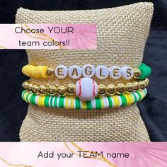 Custom Made to Order Baseball Team Heishi Bracelet Stack Get ready to show off your love of baseball with this stack of bracelets! The set includes three different bracelets ~ One is a team name with team colored beads, the second is a baseball with solid beads of gold or silver and the third is a full team mixed colored bead bracelet.  You'll feel like a true baseball fan when you wear these bracelets to the game, or out with friends.   Great for players, moms, coaches or friends or any fan of Personalized Yellow Bracelets With Round Beads, Personalized Yellow Stretch Bracelet As Gift, Customizable Green Beaded Bracelets, Customizable Green Bracelet For Personalized Gift, Yellow Beaded Letter Bracelets As Gift, Adjustable Green Beaded Bracelets For Personalized Gift, Adjustable Green Beaded Bracelets For Gifts, Customized Bracelets With Round Beads For Mother's Day, Personalized Yellow Beaded Bracelets