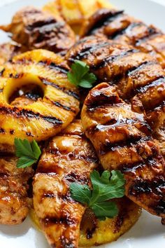 grilled chicken and pineapples on a white plate