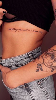 a woman with a rose tattoo on her stomach and the words, everything you need is always