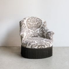 an upholstered chair with black and white fabric