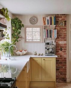 a kitchen with an oven, sink and bookshelf