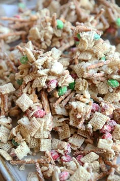 a pile of chex mix sitting on top of a metal pan covered in candy