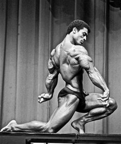 a black and white photo of a bodybuilding competitor