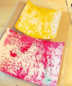 two pieces of paper that have been dyed yellow and pink