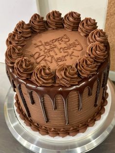 a birthday cake with chocolate frosting and icing