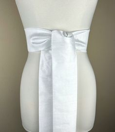 "Wide Textured White Sash Belt  White Dupioni Sash  White Dress Sash  Dupioni Fabric Belt  White Wedding Sash  Formal Dress Sash   Add sophistication and crisp texture to your special occasion outfit with this Satin Swank® dupioni waist sash. Depending on your waist size and the length you choose (75 and 90 inch lengths available), you can wrap this sash around your waist once or twice. You decide whether to tie the sash in a bow or a simple knot with long-hanging tails. Tie in front, in back, o Elegant White Dresses With Sashes, White Fitted Bridal Belt For Ceremony, Fitted Bow Sash For Bridesmaid, Fitted Satin Bow Sash For Bridesmaids, White Satin Bridal Belt With Sashes, Elegant White Bridal Belt With Satin Bow, Fitted Bridesmaid Sash With Bow, Fitted Bridesmaid Sash, Fitted Wedding Dress With Tie Waist