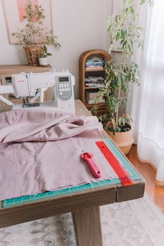 a sewing machine on a table next to a piece of cloth