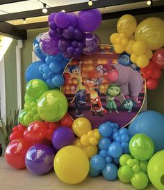 there are many balloons on the floor and in front of this photo is an image of cartoon characters