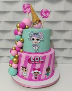 a multi layer cake decorated with candy and lollipops