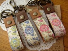 four key fobs are sitting on top of a doily