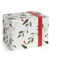 a white present box with red ribbon and holly designs on it, wrapped in paper