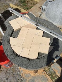 some bricks are laying on the ground next to a bucket