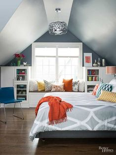 an attic bedroom with white walls and gray carpeted flooring is decorated in bright colors