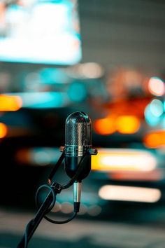 a close up of a microphone with blurry lights in the background