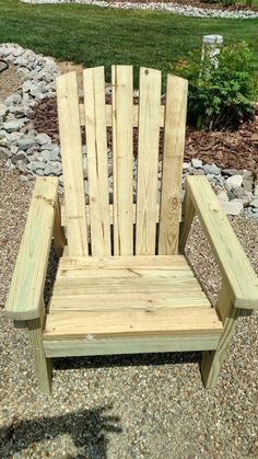 a wooden chair sitting on top of gravel