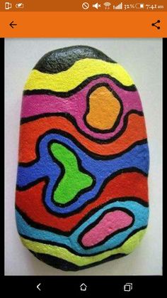 a painted rock with an abstract design on it