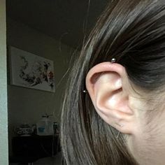 a close up of a person's ear with an object in the background