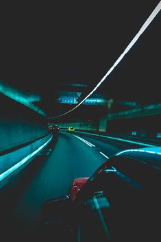 a car driving down a highway at night