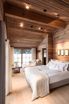 a large bed sitting inside of a bedroom on top of a hard wood floor