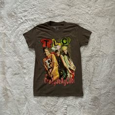 Tlc T-Shirt Unisex Size Small New Without Tags. Dead Stock Tee, Straight From Retailer. Never Worn. Perfect Condition. Oversized Fit, Full Length, Crewneck With Short Sleeves. Washed Brown Vintage Style With Multi Color Graphic Print On Front. 100% Cotton. If You Have Any Questions Feel Free To Ask:) If You Don’t Like The Price Please Send An Offer:) * All Bundle Orders Are Discounted * All Orders Are Packaged With Care And Have Same Day Or Next Day Shipping Trendy Urban Outfitters T-shirt For Streetwear, Fitted Graphic Tee From Urban Outfitters, Urban Outfitters Grunge T-shirt For Streetwear, Urban Outfitters Grunge Tops For Summer, Urban Outfitters Summer Grunge Tops, Trendy Cotton T-shirt By Urban Outfitters, Fitted Tan Graphic Print T-shirt, Tan Fitted Graphic Print T-shirt, Fitted Tan T-shirt With Graphic Print