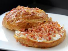 two pastries on a white plate sitting on a table