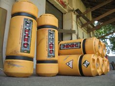 several yellow fire extinguishers sitting on the ground