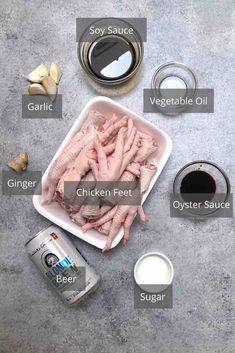 ingredients to make chicken feet on a table with spices and seasonings around it, including garlic, salt, pepper, eggplant, butter, soy sauce, and vegetable oil