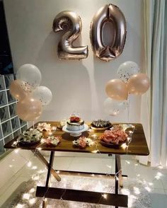 a table with balloons and cake on it in front of the number twenty two sign