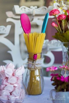 two vases filled with yellow and pink flowers