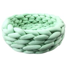 a large green bowl filled with lots of white stuff on top of a white surface