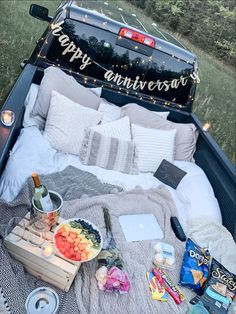 an open truck bed with food and drinks in it