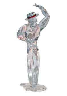 a glass figurine with a top hat on it's head and arms in the air