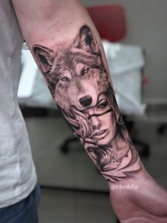 a man with a wolf tattoo on his arm