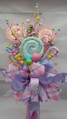 a colorful bouquet with candy and candies in it's centerpiece on a gray background