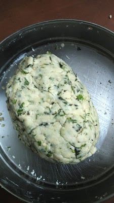 an uncooked piece of food sitting on top of a frying pan in the process of being cooked