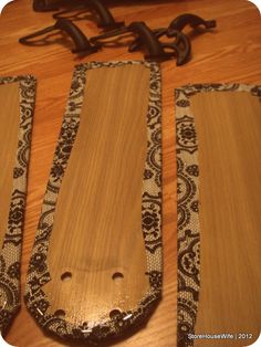 three pieces of wood sitting on top of a wooden table next to a pair of scissors