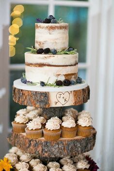 a three tiered cake sitting on top of a tree stump