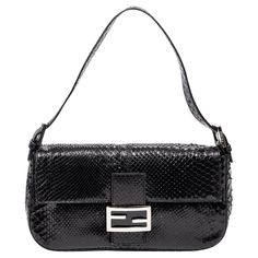 Introducing the Fendi Black Baguette: a sleek and sophisticated addition to your collection. Crafted from luxurious lizard embossed leather in classic black, this bag exudes timeless elegance. Its silver hardware adds a touch of modernity, while the magnetic snap closure offers convenience and security. Open it up to reveal a sumptuous satin-lined interior, perfect for your essentials. Elevate any outfit with this chic accessory that effortlessly combines style and functionality for the fashion-forward individual. Visit our IG @shopdecru SPECIFICS Length: 9.8" Width: 1.6" Height: 5.5" Strap drop: Adjustable, 6" Authenticity code: 2348-26424-009 Comes with: Fendi Dust bag CONDITION Overall Condition: Excellent Exterior/Interior: Faint bending to strap Vogue Collage, Black Python, Fendi Bag, Fendi Baguette, City Bag, Chic Accessories, Fendi Bags, Bending, Silver Hardware