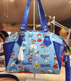 "Wallet is NOT included in this listing! It is available in a separate listing and is only shown here as an accessory. Introducing the Retro Smurf Characters Purse! Step into the magical world of Smurfs with this charming Smurf Characters purse. Travel back to the enchanting 1980s and relive the adventures of your favorite Smurf friends with this custom-designed accessory. Meticulously crafted with attention to detail, it's a delightful fusion of vintage charm and modern convenience. The exterio Retro Handmade Blue Bags, Retro Blue Handmade Bags, Custom Birthday, Playful Design, Birthday Outfit, Vintage Charms, Purses And Handbags, Top Handle Bag, Stuffed Mushrooms